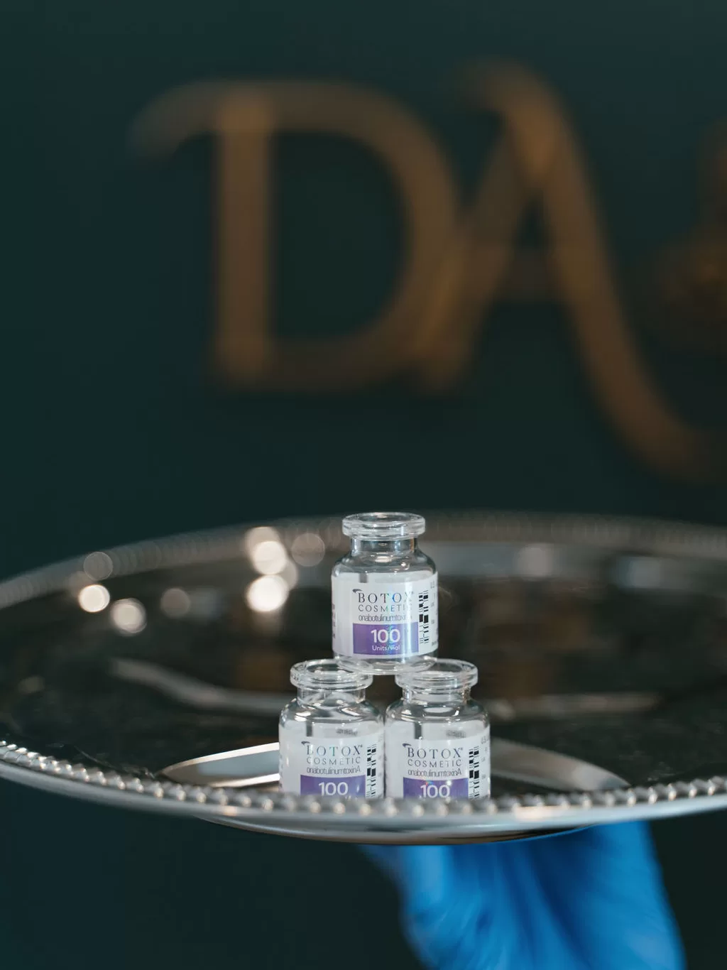 close up of BOTOX vials on a silver platter
