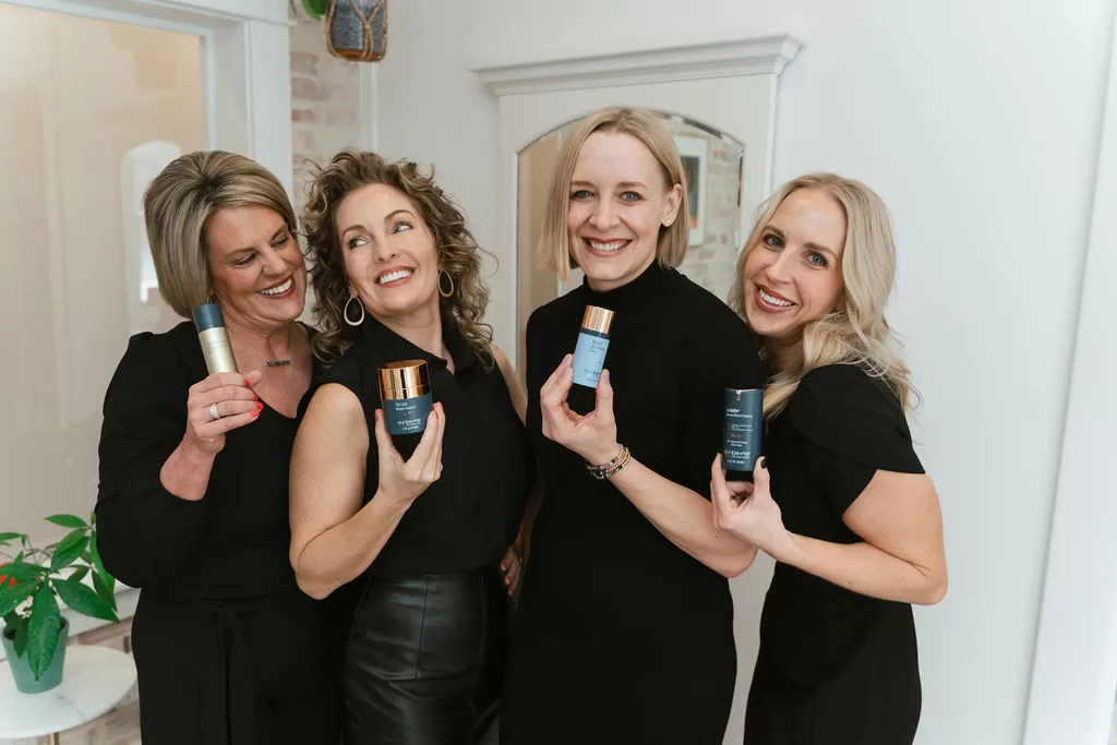 Direct Aesthetics team holding skincare products