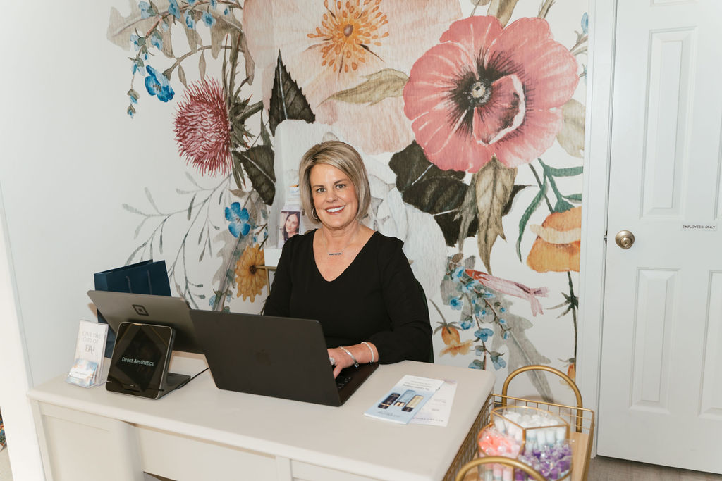 female sitting at desk in front of computer