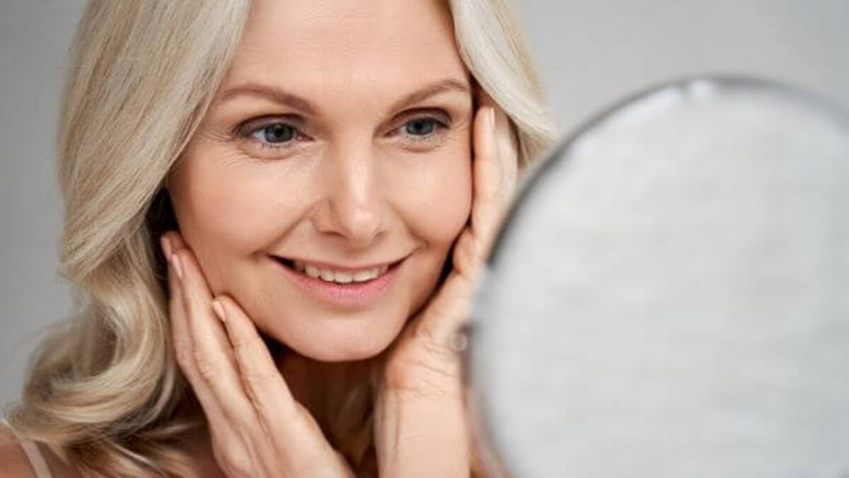 a woman looking into a mirror and smiling