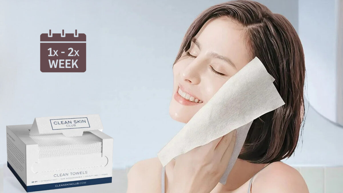 a woman exfoliating her face with clean skin club clean towels